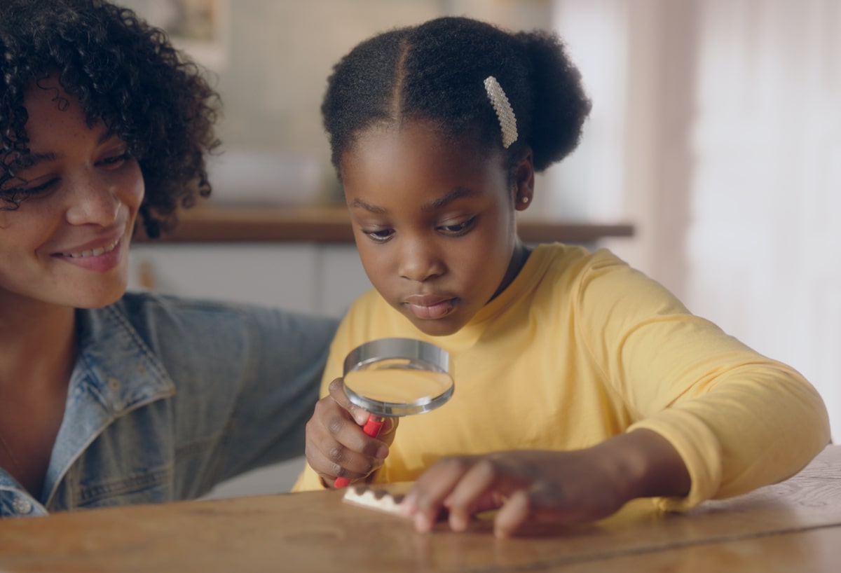 Young girl with magnifying glass 